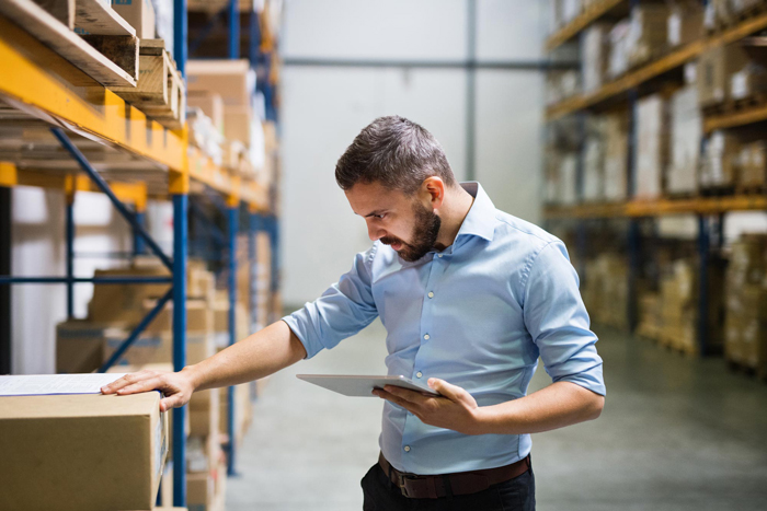 Man warehouse worker with a tablet.