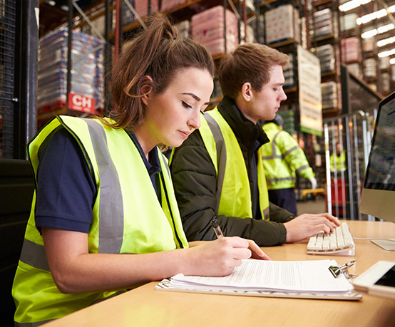 Staff managing warehouse logistics in an on-site office