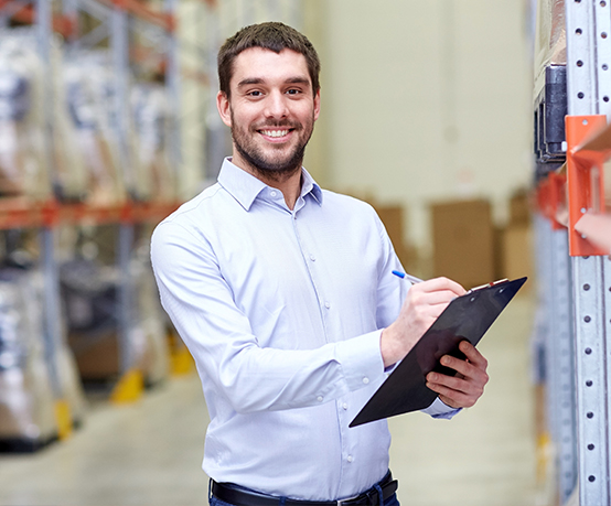 happy man or manager with clipboard at warehouse